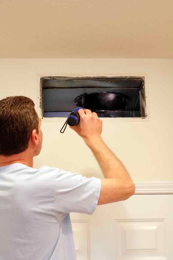a person inspecting duct work Chicago IL